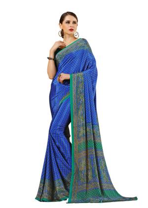 Here Is Cool Colored Saree In Blue Paired With Contrasting Sea Green Colored Blouse. This Saree And Blouse Are Fabricated On Crepe Beautified With Paisly Prints All Over. 