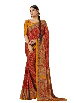 Adorn The Pretty Angelic Look, Wearing This Saree In Red Color Paired With Contrasting Musturd Yellow Colored Blouse. This Saree and Blouse Are Fabricated On Crepe Beautified With Prints all Over It.