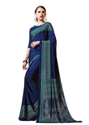Enhance Your Personality Wearing This Saree In Navy Blue Color Paired With Navy Blue Colored Blouse. This Saree And Blouse are Fabricated On Crepe Beautified With Intricate Prints All Over.