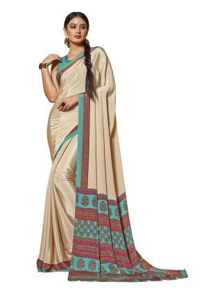 Simple And Elegant Looking Saree Is Here In Cream Color Paired With Turquoise Blue Colored Blouse. This Saree And Blouse Are Fabricated On Crepe Beautified With Prints. It Is Light Weight And Easy To Drape.