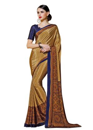 For Your Office Wear Or Formal Get Togather, Grab This Printed Saree In Beige Color Paired With Navy Blue Colored Blouse. This Saree And Blouse are Fabricated On Crepe Beautified With Prints All Over It. Buy This Saree Now.