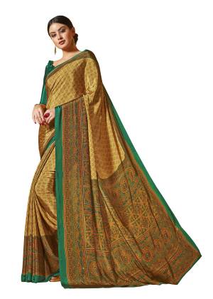 For Your Office Wear Or Formal Get Togather, Grab This Printed Saree In Beige Color Paired With Green Colored Blouse. This Saree And Blouse are Fabricated On Crepe Beautified With Prints All Over It. Buy This Saree Now.