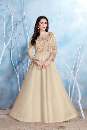Here Is a Beautiful Designer Floor Length Gown In Cream Color Fabricated On Modal Satin Beautified With Heavy Embroidery Over The Yoke. This This Gown Is Comfortable To Wear And Easy To Carry Throughout The Gala.