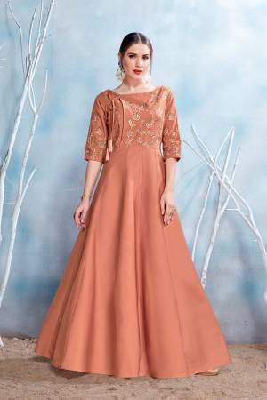A Must Have Shade In Every Womens Wardrobe IS Here With This Readymade Designer Gown In Light Brown Color Fabricated On Modal Satin Beautified With Embroidery Over The Yoke. Buy This Gown Now.