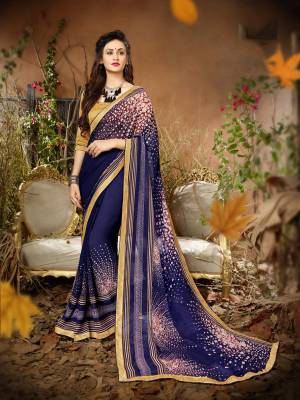 Enhance Your Personality Wearing This Saree In Navy Blue Color Paired With Beige Colored Blouse. This Saree Is Fabricated On Georgette Paired With Art Silk Fabricated Blouse. It Is Beautified With Small Floral Prints.