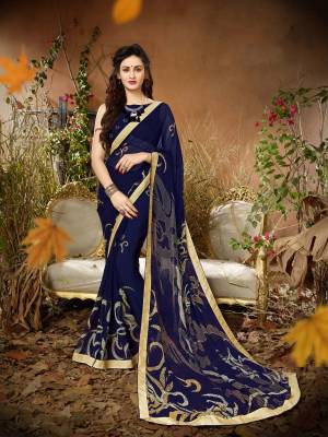Enhance Your Personality Wearing This Saree In Navy Blue Color Paired With Navy Blue Colored Blouse. This Saree Is Fabricated On Georgette Paired With Georgette Fabricated Blouse. It Is Beautified With Bold Prints All Over.