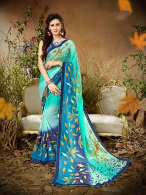 Go With The Shades Of Blue Wearing This Saree In Blue Color Paired With Blue Colored Blouse. This Saree And Blouse Are Fabricated On Georgette Beautified With Bold Floral Prints All Over.