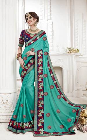 Go With The Shades Of Blue Wearing This Designer Saree In Turquoise Blue Color Paired With Navy Blue Colored Blouse. This Saree Is Fabricated On Georgette Paired With Art Silk Fabricated Blouse. It Is Beautified With Thread Embroidery And Stone Work.