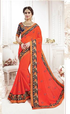Orange Color Induces Perfect Summery Appeal To Any Outfit, So Grab This Saree In Orange Color Paired With Contrasting Navy Blue Colored Blouse. This Saree Is Fabricated On Georgette Paired With Art Silk Fabricated Blouse. Buy This Designer Saree Now.