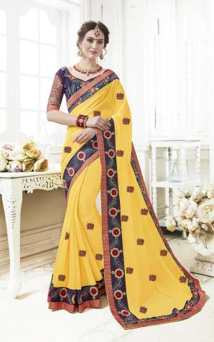 Celebrate This Festive Season Wearing This Designer Saree In Yellow Color Paired With Contrasting Navy Blue Colored Blouse. This Saree Is Fabricated On Georgette Paired With Art Silk Fabricated Blouse. Both Its Fabrics Ensures Superb Comfort All Day Long. Buy Now.