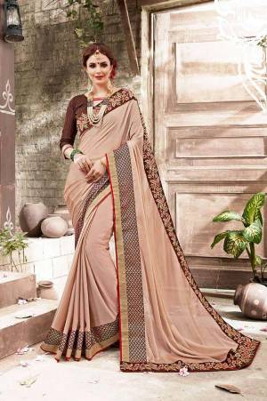 Flaunt Your Rich And Elegant Taste Wearing This Designer Saree In Beige Color Paired With Brown Colored Blouse. This Saree Is Fabricated On Chiffon Paired With Art Silk Fabricated Blouse. It Has Embroidred Lace Border Making The Saree Attractive. Buy Now.