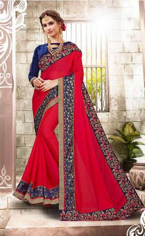 Adorn The Pretty Angelic Look Wearing This Saree In Red Color Paired With Contrasting Blue Colored Blouse. This Saree Is Fabricated On GeorgettePaired With Art Silk Fabricated Blouse. It Is Beautified With Embroidered Lace Border.