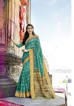 Look Pretty Wearing This Saree In Turquoise Blue Color Paired With Turquoise Blue Colored Blouse. This Saree And Blouse Are Fabricated On Cotton Silk Beautified With Prints All Over It. This Saree Is Light In Weight And Easy To Carry All Day Long.