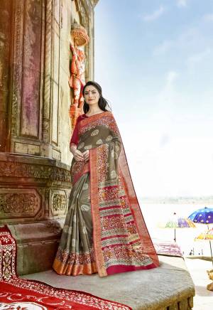 Flaunt Your Rich and Elegant Taste Wearing This Saree In Grey Color Paired With Maroon Colored Blouse. This Saree And Blouse Are Fabricated On Cotton Silk Beautified With Bold and Intricate Prints. Buy This Saree Now.