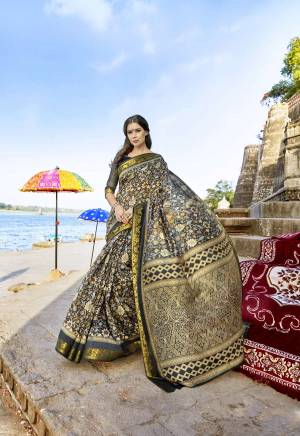 For A Bold and Beautiful Look, Grab This Saree In Black Color Paired With Black Colored Blouse. This Saree And Blouse are Fabricated On Cotton Silk Beautified With Prints. Buy This Saree Now.
