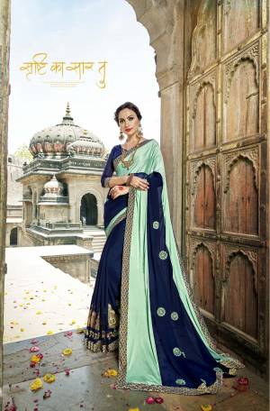 Go With The Shades Of Blue Wearing This Designer Saree In Aqua Blue And Navy Blue Color Paired With Navy Blue Colored Blouse. This Saree Is Fabricated On Lycra And Georgette Paired With Art Silk Fabricated Blouse. It Is Beautified With Simple And Elegant Embroidered Motifs.