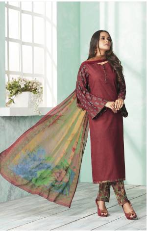 You Will Definitely Earn Lots Of Compliments Wearing this Royal Looking Straight Suit In Maroon Colored Top Paired With Multi Colored Bottom And Dupatta. Its Top And Bottom Are Fabricated On Cotton Paired With Chiffon Dupatta. Buy This Semi-Stitched Suit Now.
