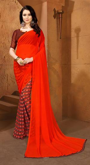 Shine Bright Wearing This Saree In Orange Color Paired With Contrasting Brown Colored Blouse. This Saree And Blouse Are Fabricated On Chiffon Beautified With Intricate Prints Over Half Saree. Buy This Saree Now.