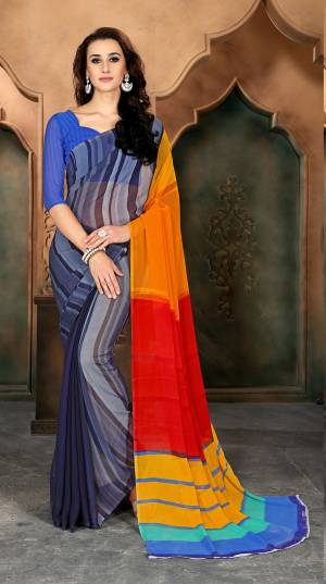 You Will Definitely Earn Lots Of Compliments Wearing this Blue And Multi Colored Saree Paired With Blue Colored Blouse. This Saree And Blouse are Fabricated On Chiffon Beautfied With Colorful Prints.