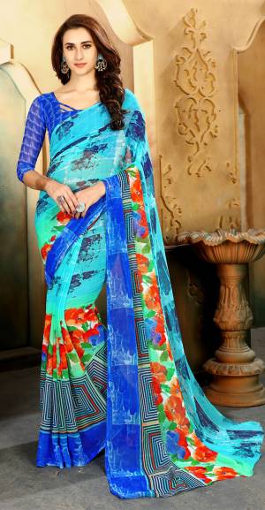 Grab This Pretty Simple Saree For your Casual Wear In Blue Color Paired With Royal Blue Colored Blouse. This Saree And Blouse Are Fabricated On Chiffon Beautified With Abstract Prints All Over It.