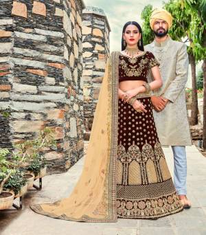 Get Ready For The Upcoming Wedding Season With This Heavy Designer Lehenga Choli In Brown Color Paired With Beige Colored Blouse. Its Blouse And Lehenga Are Fabricated On Velvet Paired With Net Fabricated Dupatta. This Designer Lehenga Choli Is Beautified With Heavy Jari And Thread Embroidery. Buy This New Color Now.