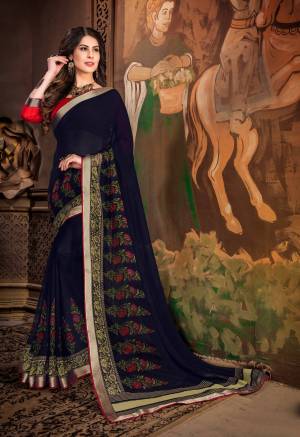 Enhance Your Personality Wearing This Saree In Navy Blue Color Paired With Contrasting Red Colored Blouse. This Saree Is Fabricated On Georgette Paired With Art Silk Fabricated Blouse. It Is Beautified With Floral Printed Motifs. Buy This Saree Now.