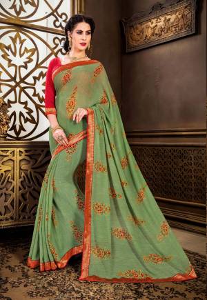 New And Pretty Shade Is Here In Green with This Saree In Sea Green Color Paired With Contrasting Red Colored Blouse. This Saree Is Fabricated On Georgette Paired With Art Silk Fabricated Blouse. Its Has Lovely Printes Motifs All Over The Saree. Buy This Saree Now.