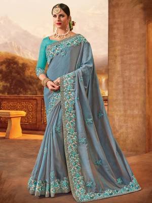 All the Fashionable women will surely like to step out in style wearing this grey color two tone silk fabrics saree. this gorgeous saree featuring a beautiful mix of designs. look gorgeous at an upcoming any occasion wearing the saree. Its attractive color and designer heavy embroidered design, Flower patch design, beautiful floral design work over the attire & contrast hemline adds to the look. Comes along with a contrast unstitched blouse.