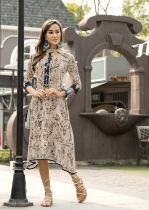 Flaunt Your Rich And Elegant Taste Wearing This Designer Readymade Kurti In Pale Grey Color Fabricated On Rayon Beautified With Prints All Over It. Pair This Up Contrasting Blue Colored Leggings And Complete The Look.