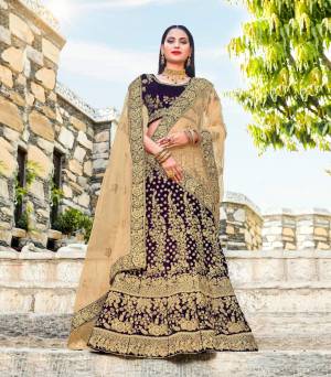 Get Ready For The Upcoming Wedding Season With This Heavy Designer Lehenga Choli In Dark Wine Color Paired With Beige Colored Blouse. Its Blouse And Lehenga Are Fabricated On Velvet Paired With Net Fabricated Dupatta. This Designer Lehenga Choli Is Beautified With Heavy Jari And Thread Embroidery. Buy This New Color Now.