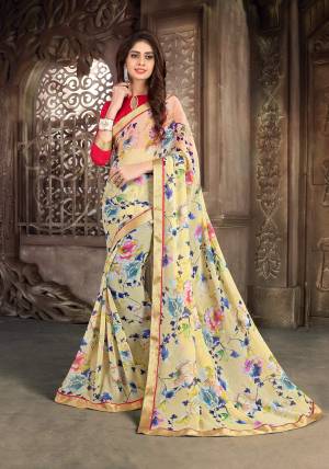 You Will Definitely Earn Lots Of Compliments Wearing This Saree In Light Yellow Color Paired With Contrasting Red Colored Blouse. This Saree Is Fabricated On Georgette Paired With Art Silk Fabricated Blouse. It Is Beautified With Bold Floral Prints All Over The Saree. Buy This Saree Now.