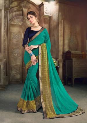 Add This Rich And Elegant Looking Saree To Your Wardrobe In Teal Blue Color Paired With Navy Blue Colored Blouse. This Saree Is Fabricated On Georgette Paired With Art Silk Fabricated Blouse. It Is Light In Weight And Easy To Carry All Day Long.