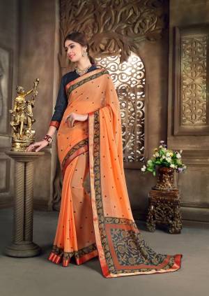 Orange Color Induces Perfect Summery Appeal To Any Outfit So Grab This Saree In Orange Color Paired With Dark Grey Colored Blouse. This Saree Is Fabricated On Georgette Paired With Art Silk Fabricated Blouse. This Pretty Saree Is Light In Weight And Easy To Carry All Day Long.