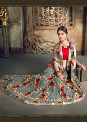 English Colored Sarees Are Must Have In Your Wardobe, Grab This Saree In Grey Color Apired With Contrasting Red Colored Blouse. This Saree Has Beautiful Red Colored Bold Floral Prints Making The Saree More Attractive.
