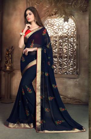 Enhance Your Personality Wearing This Saree In Navy Blue Color Paired With Contrasting Red Colored Blouse. This Saree Is Fabricated On Georgette Paired With Art Silk fabricated Blouse. Buy This Saree Now.