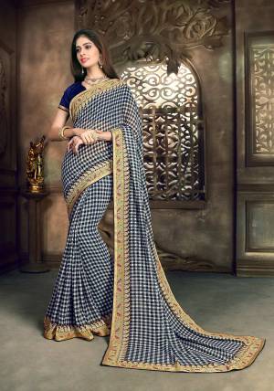 For Your Semi-Casual Wear, Grab This Saree In White And Navy Blue Color Paired With Navy Blue Colored Blouse. This Saree Is Fabricated On Georgette Paired With Art Silk Fabricated Blouse. It Is Beautified With Checks Prints All Over It. Buy Now.