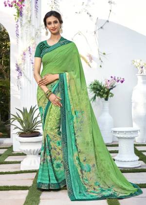 Look Fresh And Attractive Wearing This Saree In Green Color Paired With Dark Green Colored Blouse. This Saree And Blouse Are Fabricated On Georgette Beautified With Prints All Over. Buy This Casual Wear Saree Now.