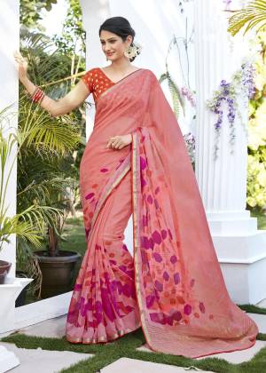Look Pretty Wearing This Saree In Baby Pink Color Paired With Contrasting Orange Colored Blouse. This Saree Is Fabricated On Chiffon Jacquard Paired With Brocade Fabricated Blouse, It Is Light Weight And Easy To carry All Day Long.
