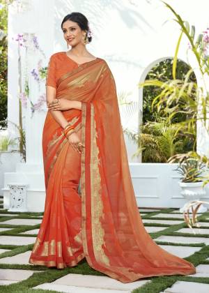 Orange Color Induces Perfect Summery Appeal To Any Outfit, So Grab This Saree In Orange Color Paired With Orange Colored Blouse. This Saree Is Fabricated On Chiffon Jacquard Paired With Brocade Fabricated Blouse. Buy This Pretty Saree Now.