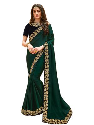 Catch All The Limelight Wearing This Attractive Designer Saree In Pine Green Color Paired With Contrasting Navy Blue Colored Blouse. This Saree Is Fabricated On Satin Silk Paired With Velvet Fabricated Blouse. It Has Beautiful Embroidered Lace Border Which Is Making The Saree Attractive. Buy Now.