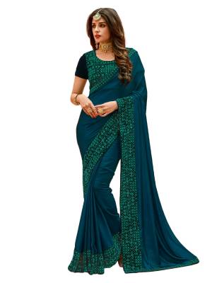 Beautiful Shade In Blue Is Here With This Saree In Teal Blue Color Paired With Contrasting Navy Blue Colored Blouse. This Saree Is Fabricated On Satin Silk Paired With Velvet Fabricated Blouse. It Has Lovely Thread Embroidered Lace Border With Stone Work. Both Its Fabrics Ensures Superb Comfort All Day Long.