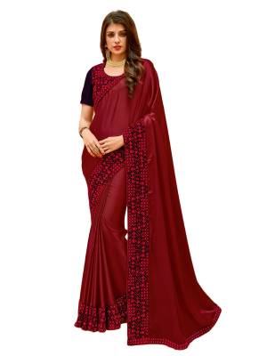 For A Royal Personality, Grab This Attractive Designer Saree In Maroon Color Paired With Dark Purple Colored Blouse. This Saree Is Fabricated On Satin Silk Paired With Dark Purple Colored Blouse. Buy This Designer Saree Now.