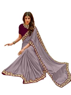 Here Is A Very Pretty Shade In Purple With This Saree In Light Purple Color Paired With Wine Colored Blouse. This Saree Is Fabricated On Satin Silk Paired With Velvet Fabricated Blouse. It Is Beautified With Attractive Embroidered Lace Border Which Will Earn You Lots Of Compliments From Onlookers.