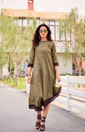 Here Is A Designer Readymade Kurti With Assymetric Pattern In Light Olive Green Color Fabricated On Soft Silk. It Is Beautified With Thread Embroidery And Stone Work. Buy Now.