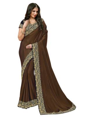 Add This Rich And Elegant Saree To Your Wardrobe In Brown Color Paired With Black Colored Blouse. This Saree Is Fabricated On Satin Silk Paired With Velvet Fabricated Blouse. It Is Beautified With Heavy Embroidery Over The Blouse And Lace Border. 