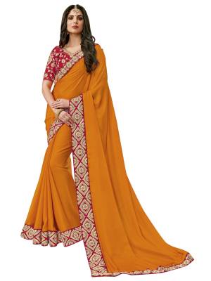 Celebrate This Festive Season Wearing This Saree In Musturd Yellow Color Paired With Contrasting Red Colored Blouse. This Saree Is Fabricated On Satin Silk Paired With Velvet Fabricated Blouse. It Has Jari And Gota Work over The Blouse And Saree Lace Border.