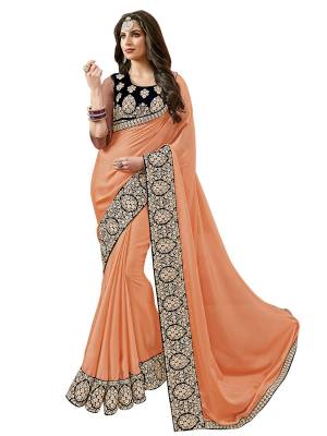 Add This Lovely Shade To Your Wardrobe Which Is In Great Demand And Running Color. Grab This Designer Saree In Peach Color Paired With Navy Blue Colored Blouse. This Saree Is Fabricated On Satin Silk Paired With Velvet Fabricated Blouse. It Is Beautified With Thread Embroidery And Stone Work.