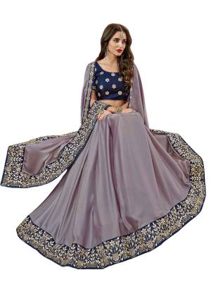New And Unique Shade Is Must To Add Up Into Your Wardrobe, Grab This Designer Saree In Mauve Color Paired With Contrasting Navy Blue Colored Blouse. This Sareee IS Fabricated On Satin Silk Paired With Art Silk fabricated Blouse. Buy This Saree Now.