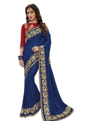 Get Ready For The Upcoming Festive And Wedding Season With This Designer Saree In Blue Color paired With Contrasting Red Colored Blouse. This Saree Is Fabricated On Satin Silk Paired With Art Silk Fabricated Blouse. It Is Beautified With Embroidery Over The Blouse And Saree Lace Border.