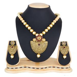 Royal Looking Necklace Set Is Here In Golden Color. This Designer Necklace Set Is Beautified With Maroon Colored Stones. Pair This Up With Your Maroon Colored Ethnic Attire And Look Like A Queen.